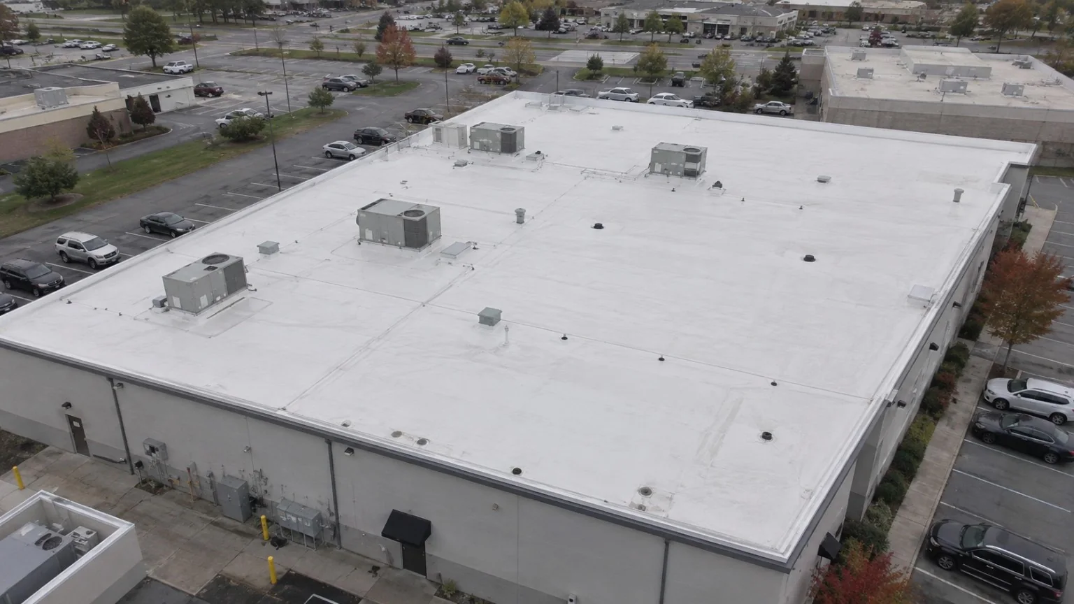 Aerial view of a completed white commercial membrane roof