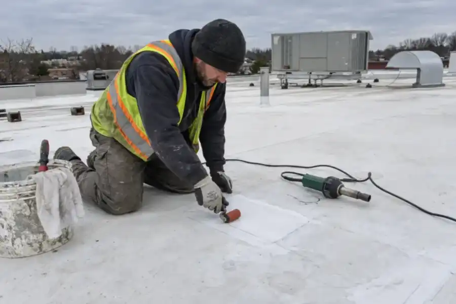 Commercial roofer completing a localized membrane repair